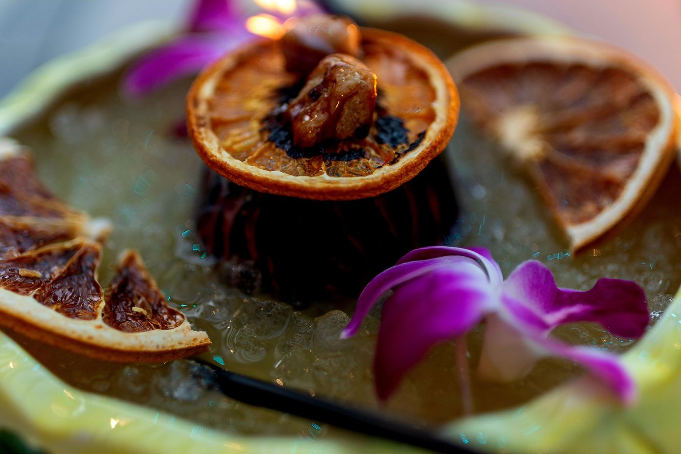 Close-up of dehydrated orange and grapefruit wheels on a tiki drink